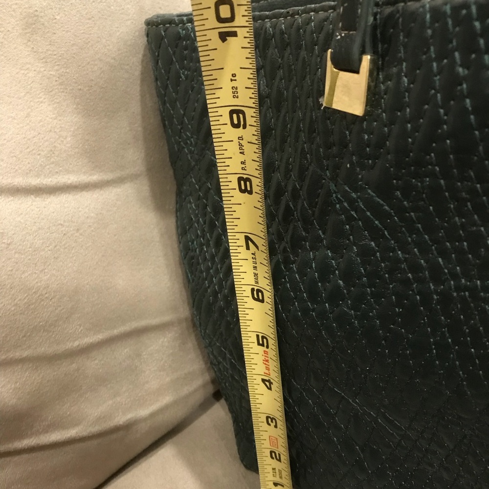 Green Ivanka Trump leather bag, peeling on side of bag.  Not that noticeable.